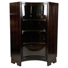 an art deco display cabinet with glass doors and wood trimmings on the sides