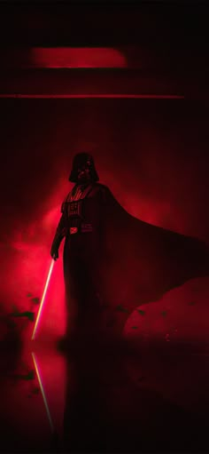 darth vader standing in the dark with red light coming from his caped