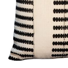 a black and white pillow on a white background