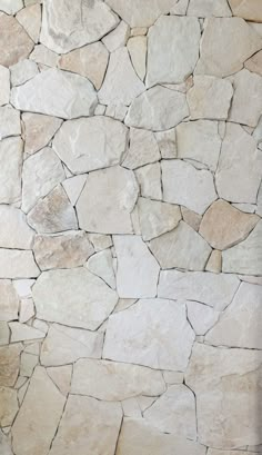 a stone wall that is made out of various types of rocks and has no mortar