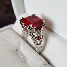 Perfect Ring For Valentine's Day! Large Red Princess Cut Center Stone With Small Red Stones On Either Side. Tons Of Great Metal Work Make An Eye Catching Ring. Set In Silvertone. Comes With A Drawstring Bag. Princess Cut Ring, Red Princess, Vampire Aesthetic, Red Stones, Princess Cut Rings, Metal Work, Red Stone, Perfect Ring, An Eye