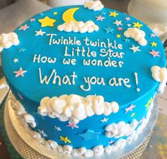 a blue cake with stars and clouds on it that says twinkle twinkle little star how we wonder what you are