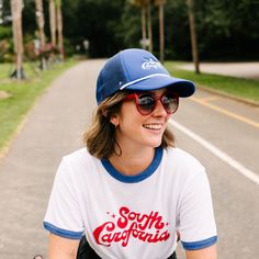 Greetings from South Carofornia! Charleston, South Carolina meets Southern California for our latest collection, inspired by the carefree vibes of a day spent skating under palm trees or chillin' at your favorite local surf spot. The retro Trucker Hat is the perfect accessory for all your So-Car adventures. Made with soft polyester and breathable nylon mesh, this hat features a contrasting white rope detail as well as our South Carofornia design hand-lettered by artist Olivia Taylor embroidered White Rope, Charleston South Carolina, Get Directions, Hand Lettered, Southern California, South Carolina, Charleston, Skating, Palm Trees