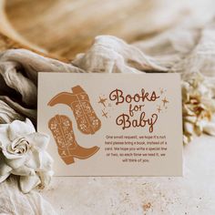 there is a card with the words books for baby on it next to some flowers