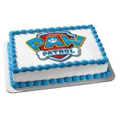 a white and blue cake with the word paw patrol on it's side, in front of a white background