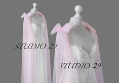 two white dresses with pink bows on them and one is in the shape of a dress