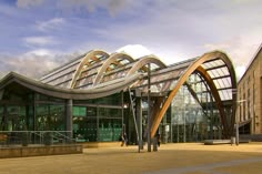 a large building with many windows on top of it's sides and a walkway leading up to the entrance