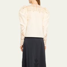 Ulla Johnson "Aura" blouse featuring cutwork lace on the shoulders and sleeves Approx. 22.8”L from shoulder to hem Round neckline; button/keyhole back Long gigot sleeves; approx. 29.4"L Hip length Relaxed fit Cotton/silk Dry clean Imported Elegant Fall Embroidered Top With Embroidered Sleeves, Fitted Embroidered Top With Long Sleeves, Long Sleeve Lace Trim Blouse For Work, Fitted Long Sleeve Top With Embroidered Sleeves, Elegant Long Sleeve Embroidered Top For Fall, Workwear Blouse With Lace Long Sleeves, Elegant Long Sleeve Lace Top, Feminine Tops With Lace Sleeves For Work, Long Sleeve Lace Blouse For Work