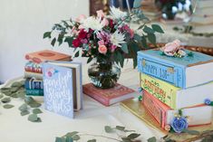 there are books and flowers on the table