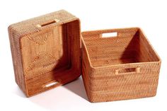 two wicker baskets sitting next to each other on a white surface with the lid open