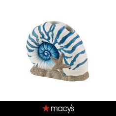 a blue and white shell with a starfish on it's side, in front of a white background