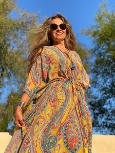 Feel like a princess when you wear our Saffron Principessa Paisley Italian silk maxi dress. Principessa in Italian means princess and is pronounced prin-chee-pessa, The rich saffron colour in this print sets off a magical multicolour mix of blues, reds, and oranges that swirl around in the detailed paisley motifs to ma Festival Paisley Print Maxi Dress, Multicolor Paisley Print Maxi Dress For Festival, Festival Multicolor Paisley Print Maxi Dress, Multicolor Paisley Print Festival Maxi Dress, Bollywood Style Maxi Dress For Festival, Bollywood Style Festival Maxi Dress, Flowy Paisley Print Maxi Dress For Festival, Bollywood Style Summer Maxi Dress, Orange Bohemian Silk Maxi Dress