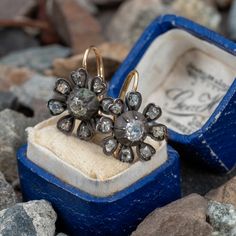 These exquisite circa mid-Victorian era sterling silver earrings feature a floral design, each centered with a bead set, old mine cut diamond. Each petal is bead set with one (1) antique cut diamond. The earrings measure 19.9mm long, including the gold lever style backs, by 15.0mm wide. We left the earrings unpolished to keep the natural rich dark patina on the finish. Flower Diamond Earrings, Old Mine Cut Diamond, Victorian Flowers, Bead Set, November Birthstone, Victorian Era, High Quality Jewelry, Estate Jewelry, Gold Accents