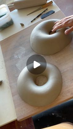 two doughnuts are being made on a table