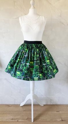 Circuti Board Skirt Gathered  full skirt made from a beautiful 100% cotton,  Circuit Board fabric. Each skirt is made by gathering the fabric onto  a 2 inch black elastic waistband. The length measures from the top of the waistband and comes in three lengths, 19", 22" or 25". Please choose length from the drop down menu. The waist measurement can be seen in the measurement guide below. Please choose waist size from the drop down menu. The skirt is pictured with a petticoat to show its potential Green Stretch Cotton Skort, Green Cotton Midi Skirt, Retro Stretch Skirt For Party, Green Stretch Tiered Mini Skirt, Green Pleated Tiered Mini Skirt, Green Flowy Mini Skirt, Green Pleated Party Skort, Green Pleated Full Skirt, Green Flowy Gathered Mini Skirt