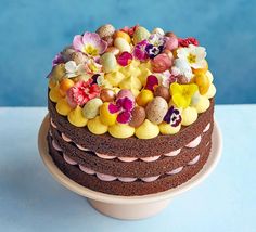 a chocolate cake with flowers and eggs on top