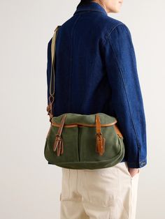 Bleu de Chauffe's messenger bag is modelled on a traditional fisherman's musette. Made at the brand's workshop in France, it's crafted from smooth green suede with brown leather buckle fastenings and a durable canvas strap. It opens up to a spacious compartment that's fitted with a zip pocket to keep your phone or cardholder secure. Porter Bag, Canvas Weekender Bag, Suede Backpack, Tom Ford Bag, Leather Weekender Bag, Canvas Messenger Bag, Wardrobe Edit, Luxury Sneakers, Messenger Bag Men