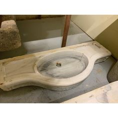 an old sink is sitting on the ground