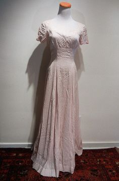 "The quintessential 1930 tea dress. Scalloped bust line and sleeves, fitted bodice, zip back, gorgeous framing of decollette, and a six gore bias cut flare to the skirt. Minor discoloration at edge of neckline in back. And how about those matching gloves that finish the look?! My mannequin has a 36 bust and 24\" waist. Length is 56\" from center neckline / collar to hem. It is fitting my mannequin as though it were made for her. The rib cage tapers to 26 under bust and to the waist to create the Classic Fitted Full-length Dress, 1950s Fitted Dress With Lined Bodice, 1950s Fitted Dresses For Vintage Events, Vintage Event Dresses With Fitted Bodice And Short Sleeves, Classic Fitted Vintage Dress For Vintage Events, Short Sleeve Dresses With Fitted Bodice For Vintage Events, Fitted Short Sleeve 1950s Dress, Vintage Short Sleeve Dress With Fitted Bodice, Fitted Bias Cut Dress With Short Sleeves