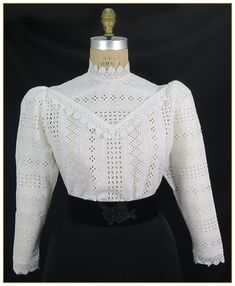 "100% Cotton. Color: White. Outstanding stripe cotton embroidered fabric blouse. Designed with matching white scalloped lace on front yoke, collar and cuffs. Full length lightly gathered sleeves, button back closure. First image shown without undergarment. Additional image shows blouse with white camisole worn underneath for modesty. Camisole undergarment not included. Machine washable. Circa 1890-1905. Made in U.S.A. Sizes: SM, MED, LG & XLG. Blouses ordered by bust measurement, inches: BUST SI Edwardian Blouse, White Camisole, Vintage Formal Dresses, Navy Skirt, Gathered Sleeves, Embroidered Fabric, Cotton Blouse, Scalloped Lace, Red And White Stripes