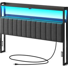 a bed with an aquarium in the middle and power cord attached to it's headboard