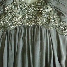 Grey Gown With Silver Stone Detail Perfect For A Wedding Or A Dressy Function Sequined Evening Dress For Wedding, Evening Sequined Mother Of The Bride Dress, Evening Sequined Wedding Dress, Sequin Mother Of The Bride Evening Dress, Glamorous Ball Gown For Mother Of The Bride, Gray Wedding Dresses For Prom Season, Sleeveless Gray Party Gown, Gray Sleeveless Party Gown, Gray Wedding Gown With Sweep Train