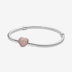 Put some love in your look with our classic Pandora Moments Pavé Heart Clasp Snake Chain Bracelet that's been given a romantic update with a heart-shaped, 14k rose gold-plated clasp. The pretty heart is detailed with cubic zirconia for a sparkling finish. The sterling silver style transitions effortlessly from day to night – and we think it looks equally elegant worn with or without charms, solo or stacked. Wear it to show more of the things you love. - Pandora Moments Pavé Heart Clasp Snake Chain Bracelet - Sterling silver and 14k Rose gold-plated unique metal blend / Cubic Zirconia / Clear - Sz. 9.1 in Bead Snake, Pretty Heart, Bracelet Pandora, Snake Chain Bracelets, Mesh Bracelet, Jewellery Uk, Pandora Bracelets, Bracelet Collection, Pandora Bracelet