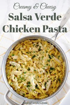 creamy and cheesy salsa verde chicken pasta in a pan with a serving spoon