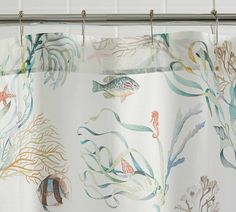 a shower curtain with fish and corals on it