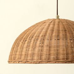 a wicker light fixture hanging from a ceiling