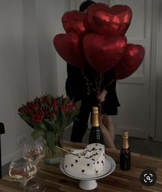 a cake and some balloons on a table