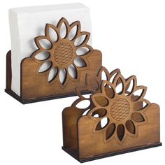 two wooden napkin holders with pineapples on them, one is white and the other is brown