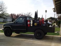 a black truck parked in front of a house