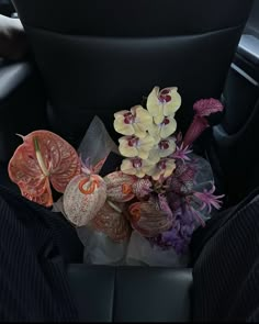 flowers are sitting in the center console of a car