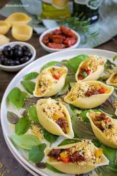 an assortment of appetizers on a plate with olives