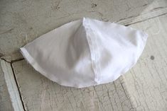 a piece of white cloth sitting on top of a wooden floor