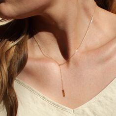 "Our dainty lariat necklace is stylish and minimalist. This dainty necklace is perfect with your favorite tee or your little black dress. A tiny bar adorns a silver or gold chain.  D E T A I L S *Dainty 12mm bar  *Hammered by hand  *2 inch drop  *Dainty link chain *100% 14kt gold-filled or sterling silver LENGTH *The standard length is normally 18\". *Model is wearing a 16\" in Photos. HOW TO PERSONALIZE *Select your choices from the drop down menu to create your custom design. ∙ EXTRA LOVE ∙ Handcrafted just for you in sunny Arizona by a team of talented women. All of our jewelry comes gift packaged! We are happy to leave a note if this is a special gift, just let us know in the message box at checkout. PRODUCTION ∙ TIMES All items are made to order. Please check the estimated delivery in Minimalist Bar Necklace With Adjustable Chain For Everyday, Adjustable Rose Gold Lariat Necklace, Minimalist Charm Necklaces With Delicate Chain, Rose Gold Lariat Necklace With Delicate Chain, Dainty Adjustable Lariat Necklace, Minimalist Dangle Drop Necklace With Clavicle Chain, Minimalist Lariat Drop Necklace With Adjustable Chain, Dainty Lariat Necklace With Adjustable Long Drop, Adjustable Rose Gold Dainty Lariat Necklace