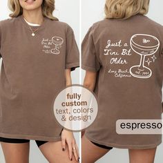 Celebrate in style with our custom martini bar t-shirt! Perfect for bachelorette parties, birthdays, and gifts for martini lovers, this tee can be personalized with your city and name of choice. It is ideal for any special occasion and adds a unique touch to your event. Stand out and make lasting memories with this elevated customizable t-shirt! 🍸✨ All text, colors, and elements can be modified - including whether you want the design as a large front design only! Please message me with any othe Custom Text Crew Neck Top For Anniversary, Anniversary Tops With Funny Text And Short Sleeves, Anniversary Custom Print Short Sleeve Tops, Anniversary Tops With Custom Print And Short Sleeve, Funny Text Crew Neck Top For Anniversary, Fitted Short Sleeve Tops For Anniversary, Party Shirt With Custom Print Short Sleeve, Party Shirt With Custom Print And Short Sleeves, Customizable Crew Neck Tops For Bachelorette Party