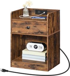 a small wooden shelf with an electronic device and books on it's bottom shelf