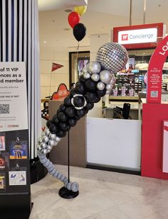 a bunch of balloons that are in the shape of a man's head and legs