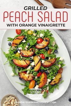 grilled peach salad with orange vinaie and blueberries on a white plate