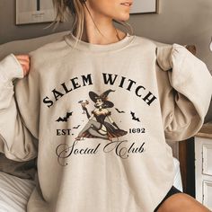 The comfortable fit and cool design of this Halloween social club sweatshirt means that it feels just as good to wear as it is to look at. If you've been looking for a spooky sweatshirt for yourself, or your favorite witchy friend, you should get this sweatshirt today. Ideal for any situation, a unisex heavy blend crewneck sweatshirt is pure comfort. These garments are made from polyester and cotton. This combination helps designs come out looking fresh and beautiful. The collar is ribbed knit, Vintage Halloween Long Sleeve Sweatshirt, Vintage Long Sleeve Halloween Sweatshirt, Witchy Long Sleeve Sweatshirt For Fall, Retro Witch, Halloween Social, Spooky Sweatshirt, Witch Sweatshirt, Salem Witch, Club Sweatshirts