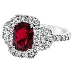 A contemporary piece of jewelry, showcasing a GRS certified color-rich 2.32 carats cushion cut ruby, set on a classic four prong setting. Accented by a halo of round cut diamonds that continue on to the shank in a half-way composition, weighing 0.74 carat total. Flanked by two half moon diamonds weighing 0.29 carat total. Finely made with 18K white gold. Size 6.5 US, resizable upon request. Roman Malakov is a custom house, specializing in creating anything you can imagine. If you would like to r Classic Cushion Cut Brilliant Gemstones, Red Diamond Ring With Brilliant Cushion Cut, Red Cushion Cut Brilliant Diamond Ring, Red Cushion Cut Diamond Ring With Brilliant Cut, Luxury Gia Certified Cushion Cut Ruby Ring, Classic Gia Certified Diamond Ring With Lab-created Ruby, Cushion Cut Diamond Fine Jewelry, Luxury Red Cushion Cut Ruby Ring, Gia Certified Cushion Cut Ruby Ring For Formal Occasions