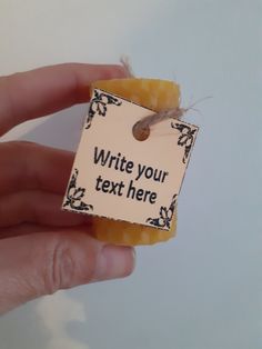 a hand holding a piece of soap with a tag on it that says write your text here