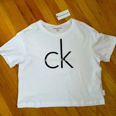 Size Small, White Crop Top, By Ck Is Light Weight And Fits Just Below Your Waist Line. Calvin Klein Cotton Tops With Logo, Calvin Klein Cotton Logo Tops, Calvin Klein Logo Cotton Tops, Trendy White Calvin Klein Top, Trendy Calvin Klein White Top, Calvin Klein Crop Top, Crop Top Camisole, Calvin Klein Sports Bra, Womens Black Vest