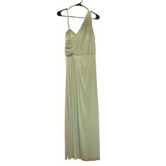 a green dress hanging on a hanger