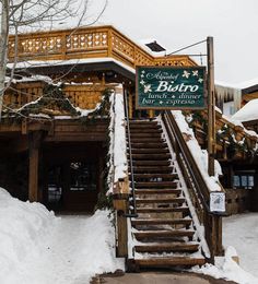 stairs leading up to a restaurant with snow on the ground