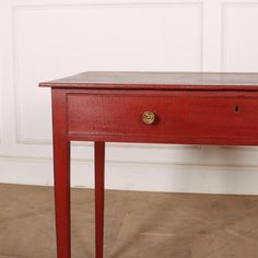 a small red table with two drawers on each side and one drawer at the top