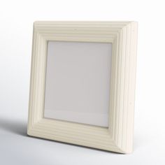 an empty white frame on a plain surface