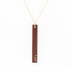 PRICES MAY VARY. 5TH ANNIVERSARY NECKLACE: Wood pendant necklace with 5 gold inlay dots set into the wood representing 5 years of marriage or partnership. The wood is sanded silky smooth to the touch and finished with a natural oil. MATERIALS: Pau Ferro wood and 14K gold fill BAR PENDANT DIMENSIONS: 44mm x 6mm x 3mm CHAIN LENGTH: 16" or 18" with 2" extension chain for extra length versatility (model in listing image is wearing 16") PACKAGING: This piece will arrive beautifully packaged in our si Anniversary For Wife, Gold Bar Pendant Necklace, Gold Bar Pendant, Wood And Gold, Wood Anniversary, Anniversary Necklace, 5 Year Anniversary, Necklace Wood, Bar Pendant Necklace